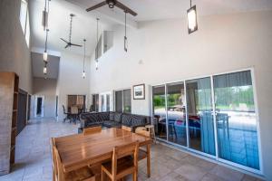 a living room with a wooden table and a couch at SWISS 105 - Lake Olsen in Clermont