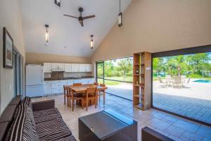 a large kitchen with a table and a dining room at SWISS 105 - Lake Olsen in Clermont +29 photos
