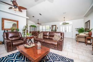 a living room with leather furniture and a table at SWISS 56 - Lake Denise in Clermont +34 photos
