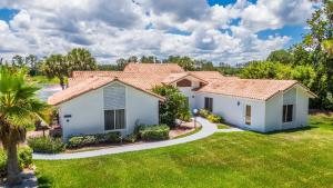 a row of white houses with a green yard at SWISS 57 - Lake Denise in Clermont