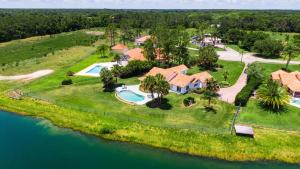 an aerial view of a home with a swimming pool and a house at SWISS 57 - Lake Denise in Clermont