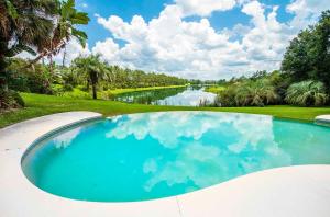 a swimming pool with a view of a river at SWISS 66 - Lake Denise in Clermont