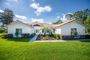 a white house with a green lawn at SWISS 66 - Lake Denise in Clermont