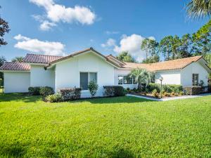 a white house with a green lawn in front of it at SWISS 66 - Lake Denise in Clermont