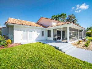 a white house with a lawn in front of it at SWISS 66 - Lake Denise in Clermont +22 photos