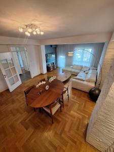 a living room with a table and a couch at PENTHAUS apartment in Banja Luka