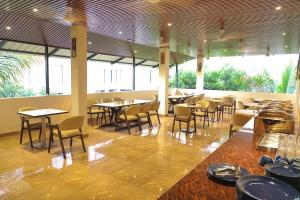 a dining room with tables and chairs in a restaurant at Ocean n' Sand - By Q23 Resorts & Suites in Candolim