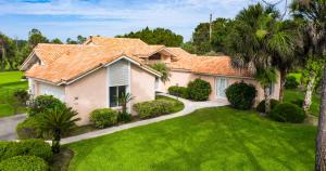 a house with an orange roof on a green yard at SWISS 30 - Golf Course in Clermont