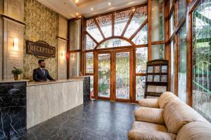 a man standing at a bar in a lobby at Ocean n' Sand - By Q23 Resorts & Suites in Candolim +40 photos