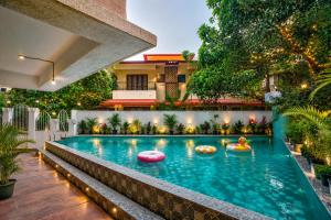 a swimming pool in the middle of a building at Ocean n' Sand - By Q23 Resorts & Suites in Candolim