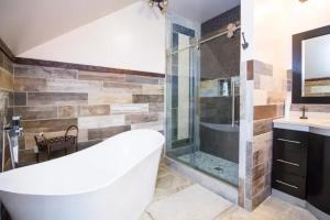 a bathroom with a tub and a shower and a sink at Cowgirl Palace in Sag Harbor +12 photos