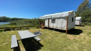 a yurt with a picnic table and a bench at Ruby Glamping tent - tent site #9 in Klamath