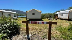 a sign with a tiny house on top of it at Ruby Glamping tent - tent site #9 in Klamath