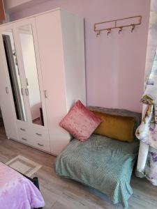 a bedroom with a bed and a mirror at liana house 3 in Skála Loutrón