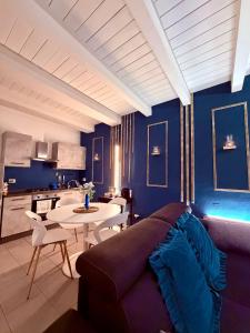 a living room with blue walls and a couch and a table at AMA Esclusive SPA Bologna in Bologna