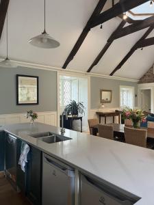 a kitchen with a sink and a dining room at Number 6 Narrow Water Castle in Warrenpoint