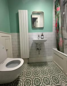 a bathroom with a toilet and a sink at Number 6 Narrow Water Castle in Warrenpoint +31 photos