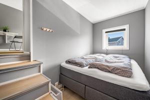 a bedroom with a bed and a window at Kronborg marina in Averoy