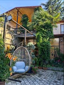 a swing sitting in front of a house at Hotel and Restaurant "VILLA GIVISI" in Lagodekhi