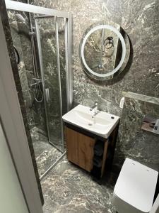 a bathroom with a sink and a shower and a toilet at ABBA Hotel in Kyiv