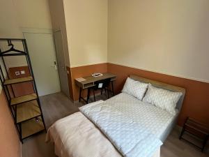 a bedroom with a bed and a small table at ABBA Hotel in Kyiv