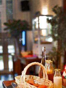 a table with a basket and two bottles of honey at Logis Hôtel Cartier in Quillan