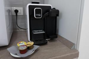a drink dispenser with two cups of coffee in a room at B&B Sibi in Chieti