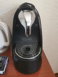 a black electric kettle sitting on a wooden table at Apartman Klara in Karlobag