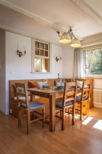 a dining room with a wooden table and chairs at 3BR Central Pool Sauna Gym & Views in Verbier +39 photos
