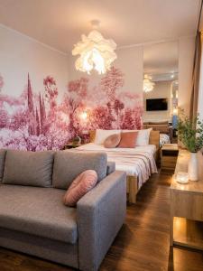 a living room with a bed and a couch at Central City Balcony Apartments in Mukacheve