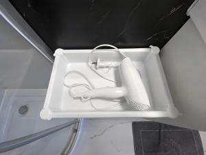 a white sink with a hair dryer in it at ECO HOUSE in Szypliszki