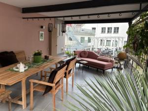 a patio with a couch and a table and chairs at Haus Enisa in Horgen