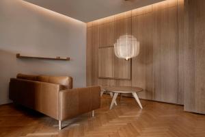 a living room with a couch and a table at Woodline Suite in Luxembourg