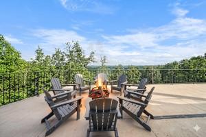 a group of chairs sitting around a fire on a patio at Mountain View Escape in Taylors