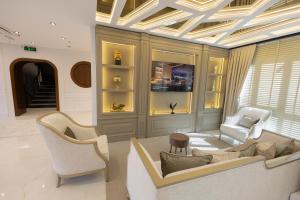a living room with a couch and two chairs at Nearest Airport Hotel in Arnavutköy