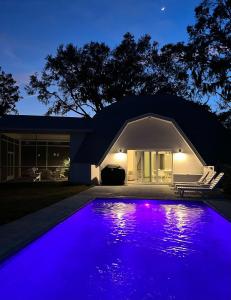 a house with a swimming pool at night at Sumner Lake House 3B in Clermont