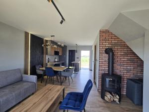 a living room with a couch and a fireplace at Panorama Sudety in Nowa Bystrzyca