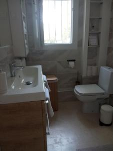 a bathroom with a sink and a toilet and a window at Appartement Fort Lamalgue in Toulon +17 photos