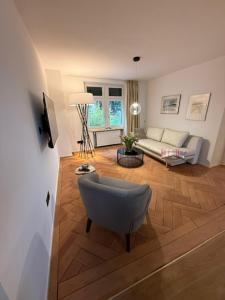 a living room with a couch and a chair at Haus Enisa in Horgen