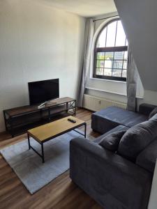 a living room with a couch and a coffee table at Pottblick Oberhausen in Oberhausen