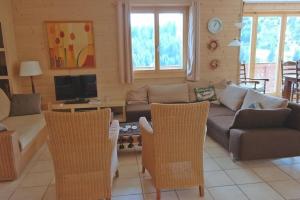 a living room with a couch and chairs and a tv at Moilles 13 in Arni Alp