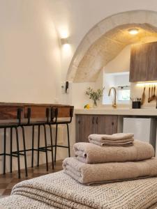 a pile of towels sitting on top of a table in a kitchen at La Suite di Alizeh in Ostuni