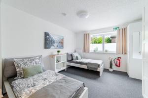 a bedroom with a bed and a couch and a window at Jans 4 Personen Work Apartment mit Küche P WLAN Code NRW Veltins Arena in Herten