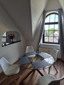 a dining room with a glass table and chairs at Pottblick Oberhausen in Oberhausen