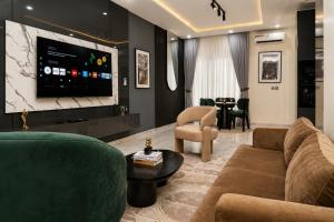 a living room with a couch and a flat screen tv at The COZY CREST in Akure