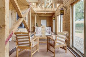 a porch with two chairs and a table and a chandelier at Hiking, Wineries & More! Mtn-View Gem in Tehachapi in Tehachapi