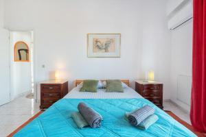 a bedroom with a large bed with blue sheets and pillows at Marine Freestyler Glorious Terrace in Faro