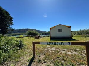 a sign in a field with a small building at Emerald - Glamping tent in Klamath