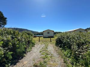 a house in the middle of a field of crops at Emerald - Glamping tent in Klamath