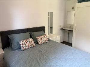 a bedroom with a bed with two pillows on it at De Duinrand in Oostkapelle